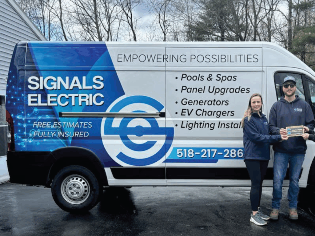 signals electric showing off ARCC badge in front of company vehicle