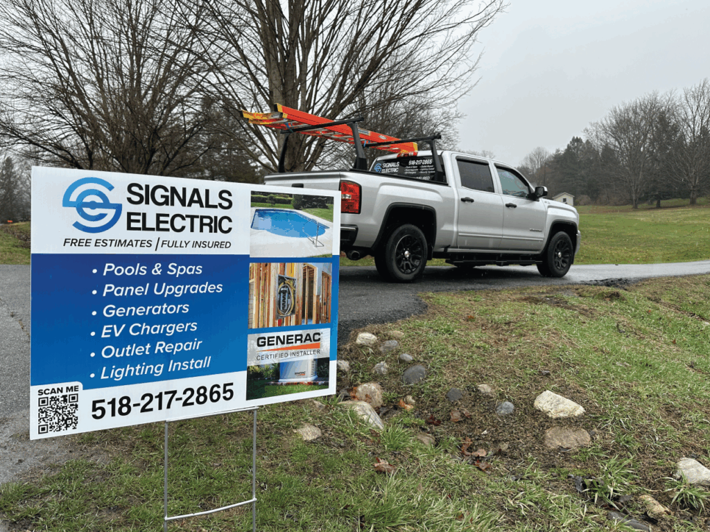 Signals Electric yard sign with technician's truck in the background