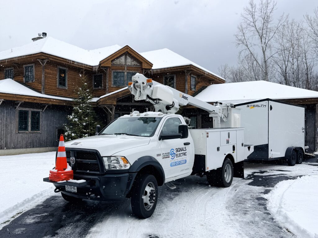Signals Electric bucket truck in front of a home in Upstate NY